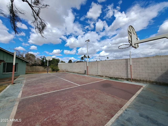 view of basketball court with fence and basketball court