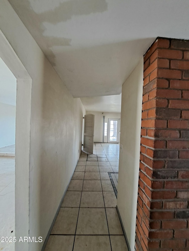 corridor with light tile patterned floors