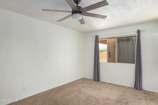 spare room with light colored carpet and ceiling fan