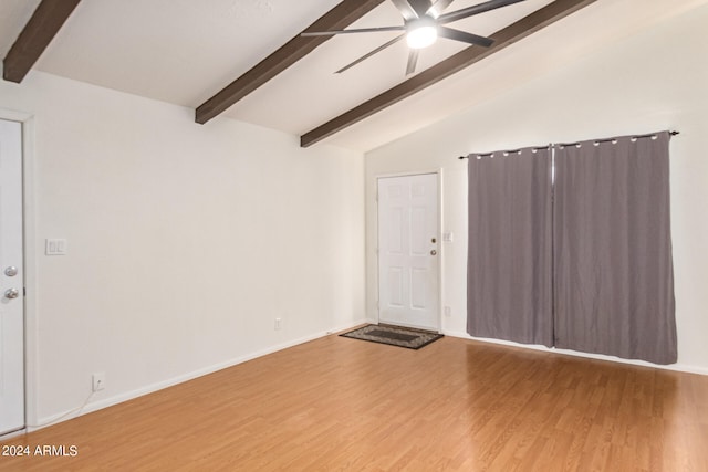 interior space with wood-type flooring, ceiling fan, and vaulted ceiling with beams