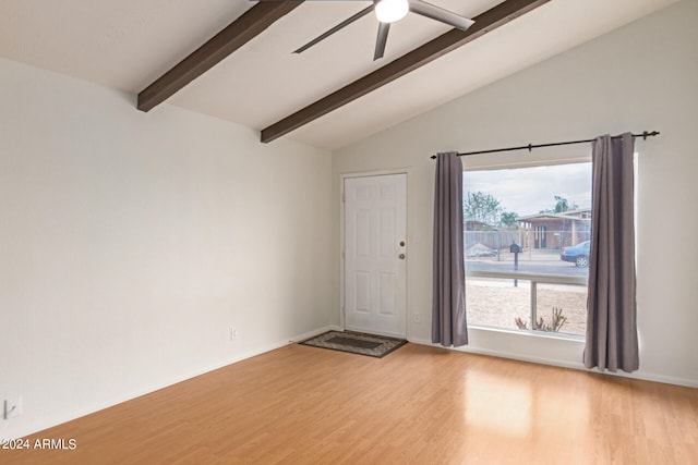 unfurnished room featuring ceiling fan, lofted ceiling with beams, and light hardwood / wood-style flooring