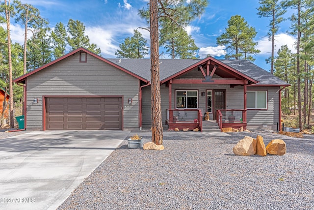 670 S Mountain Pines Ave, Show Low, AZ 85901 - view of front of home featuring covered porch, concrete driveway, an attached garage, and roof with shingles