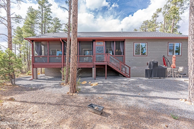 670 S Mountain Pines Ave, Show Low, AZ 85901 - back of property with a sunroom, stairway, and a shingled roof