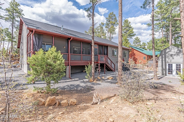 670 S Mountain Pines Ave, Show Low, AZ 85901 - back of house featuring a sunroom, stairway, a shingled roof, french doors, and an outbuilding