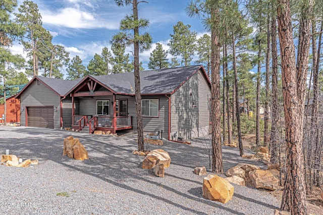 670 S Mountain Pines Ave, Show Low, AZ 85901 - view of front of home featuring an attached garage, asphalt driveway, and covered porch