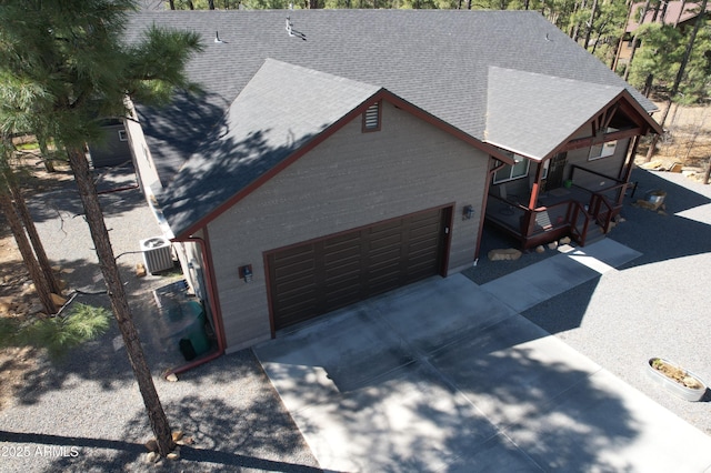 670 S Mountain Pines Ave, Show Low, AZ 85901 - view of front facade featuring roof with shingles, driveway, a porch, and an attached garage