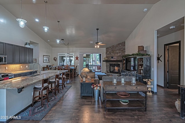 670 S Mountain Pines Ave, Show Low, AZ 85901 - living area featuring high vaulted ceiling, dark wood finished floors, ceiling fan, and a stone fireplace