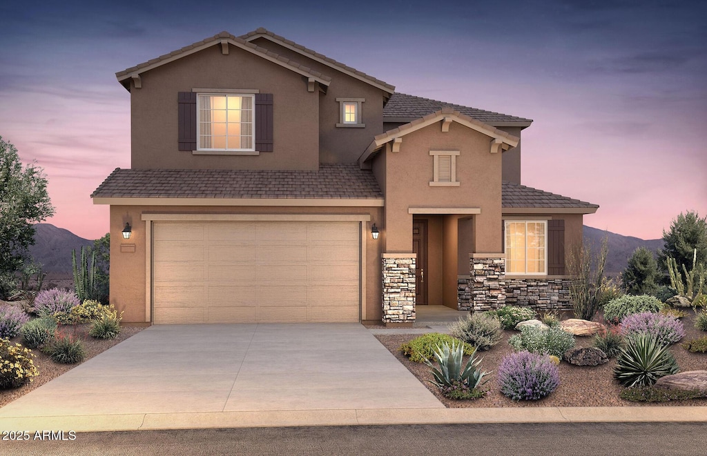 front of property featuring a garage and a mountain view