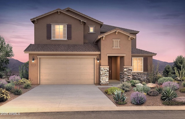 front of property featuring a garage and a mountain view