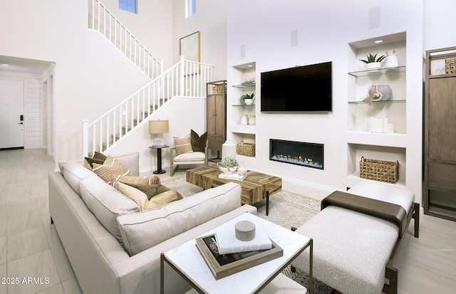 living room featuring a towering ceiling and built in features