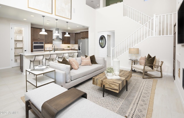 living room with sink and a towering ceiling