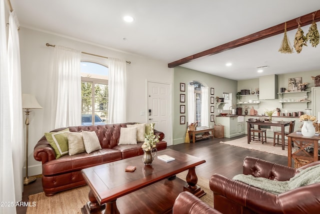 living room with dark hardwood / wood-style flooring and beam ceiling