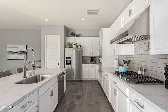 kitchen featuring light stone countertops, sink, white cabinets, and appliances with stainless steel finishes