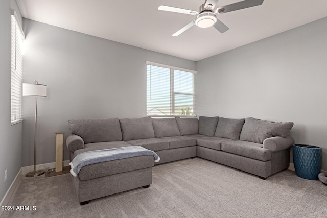 carpeted living room featuring ceiling fan