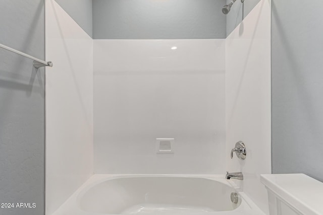 bathroom featuring toilet and shower / washtub combination