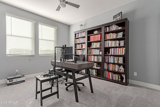 office space featuring ceiling fan and light carpet