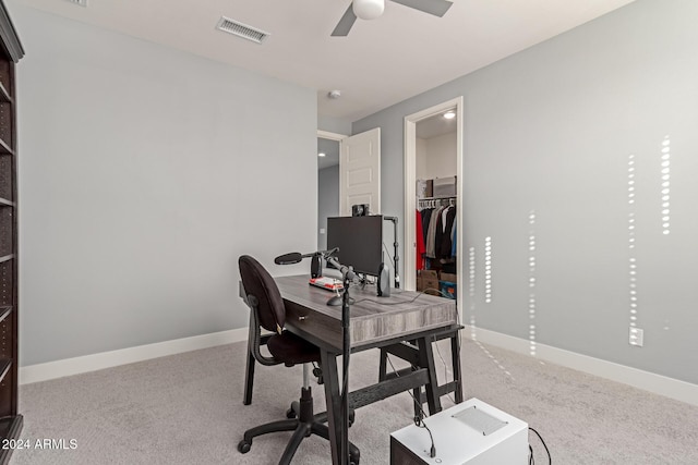 carpeted home office with ceiling fan