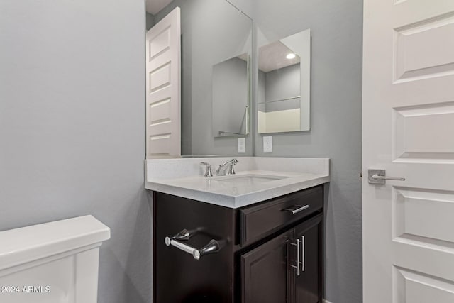 bathroom featuring vanity and toilet