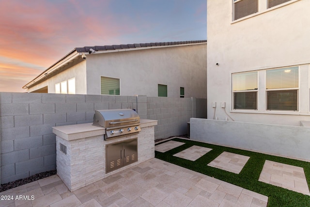 patio terrace at dusk with area for grilling and grilling area