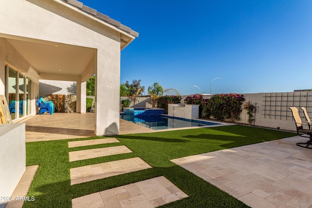 view of yard featuring a fenced in pool and a patio area