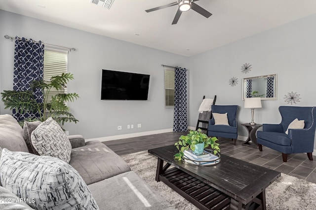 living room with ceiling fan and dark hardwood / wood-style flooring