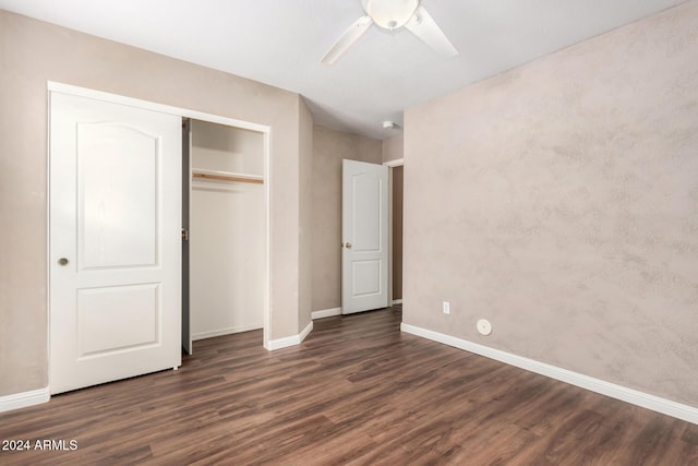 unfurnished bedroom featuring ceiling fan, dark wood-type flooring, and a closet