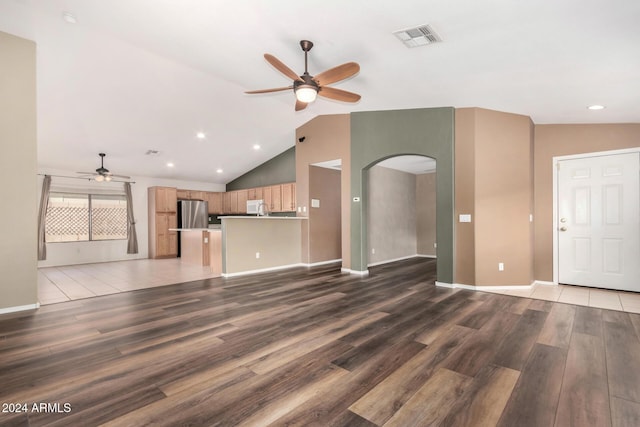 unfurnished living room featuring ceiling fan, dark wood-type flooring, and high vaulted ceiling