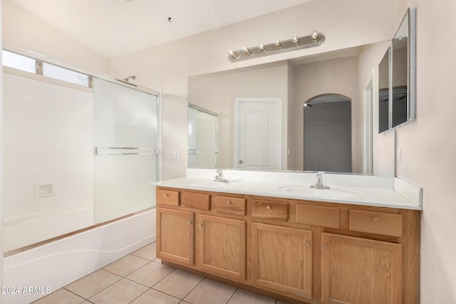 bathroom featuring vanity, vaulted ceiling, ceiling fan, shower / bath combination with glass door, and tile patterned flooring