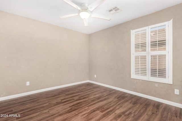 spare room featuring ceiling fan and dark wood-type flooring