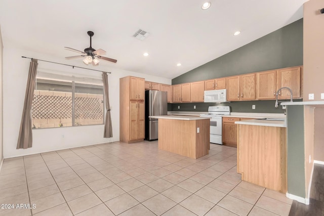 kitchen with a center island, white appliances, sink, ceiling fan, and light tile patterned floors