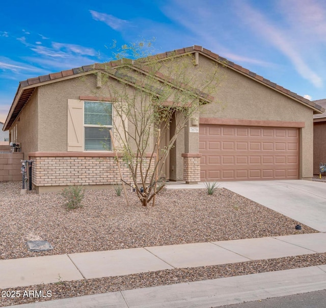 7679 S Caminito Mambla, Tucson, AZ 85756 - single story home featuring brick siding, a tile roof, concrete driveway, stucco siding, and a garage