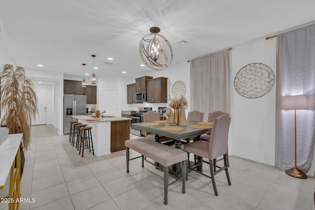 dining room with a notable chandelier, light tile patterned flooring, and recessed lighting