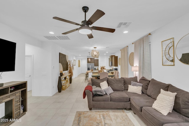 living room featuring light tile patterned flooring, visible vents, and recessed lighting