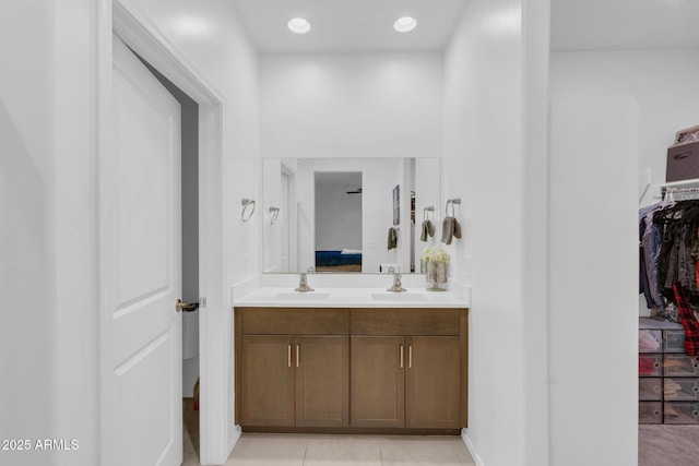 ensuite bathroom featuring vanity, ensuite bath, recessed lighting, tile patterned flooring, and a spacious closet