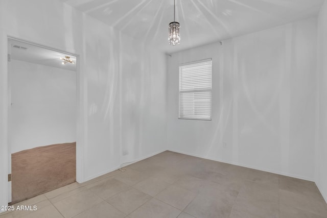 unfurnished room with a notable chandelier, visible vents, baseboards, and light tile patterned flooring