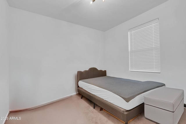 bedroom featuring baseboards and carpet flooring