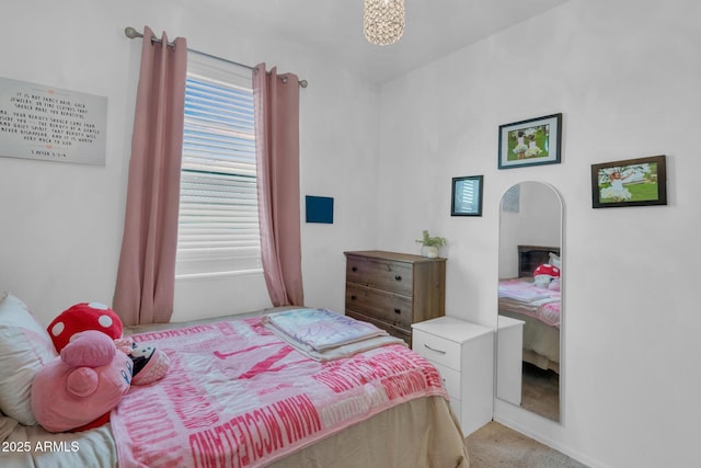 bedroom featuring arched walkways and light colored carpet