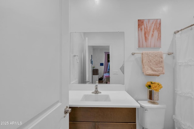 ensuite bathroom with toilet, vanity, and ensuite bathroom