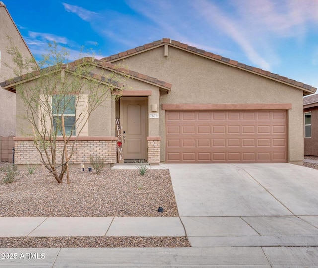 single story home featuring brick siding, stucco siding, a garage, and driveway