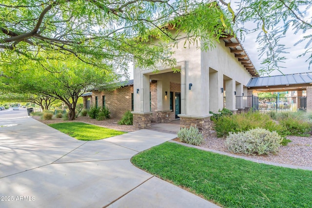 exterior space featuring a lawn and fence