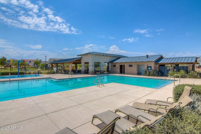 pool with a patio and fence