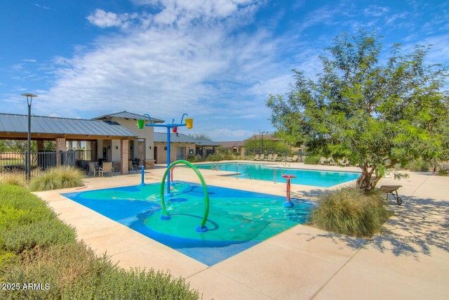 community pool featuring a patio and fence