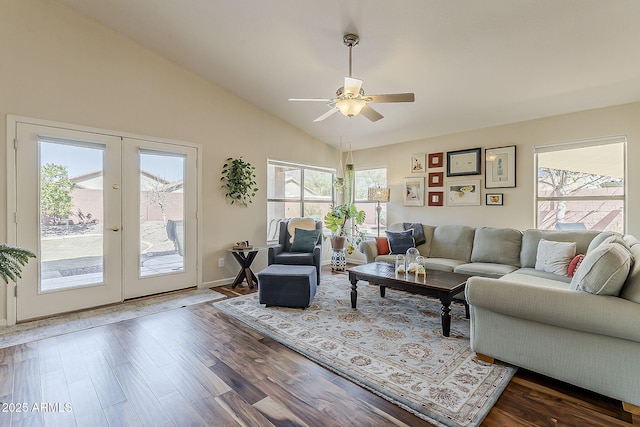 living room featuring a ceiling fan, baseboards, dark wood finished floors, vaulted ceiling, and french doors