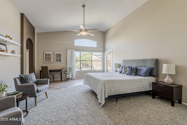 bedroom featuring light tile patterned floors, high vaulted ceiling, arched walkways, ceiling fan, and light carpet