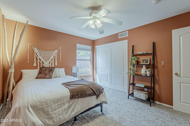 carpeted bedroom featuring visible vents, baseboards, a closet, and ceiling fan