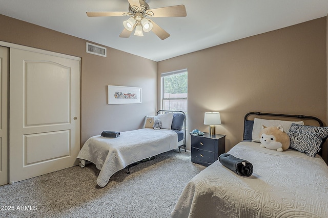 carpeted bedroom with visible vents and ceiling fan