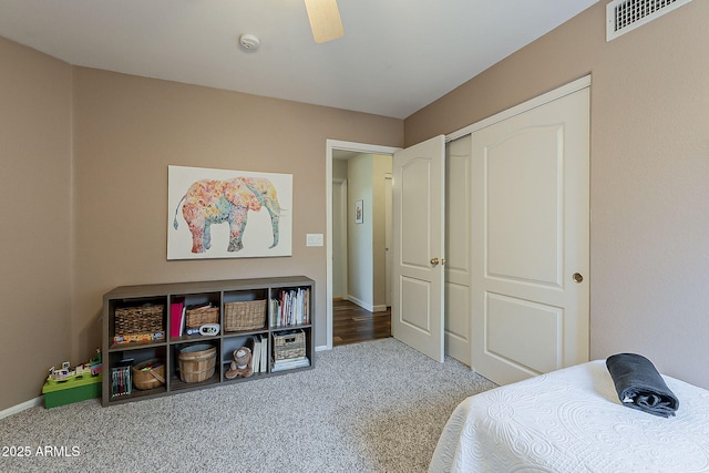 bedroom featuring visible vents, baseboards, carpet, and a closet