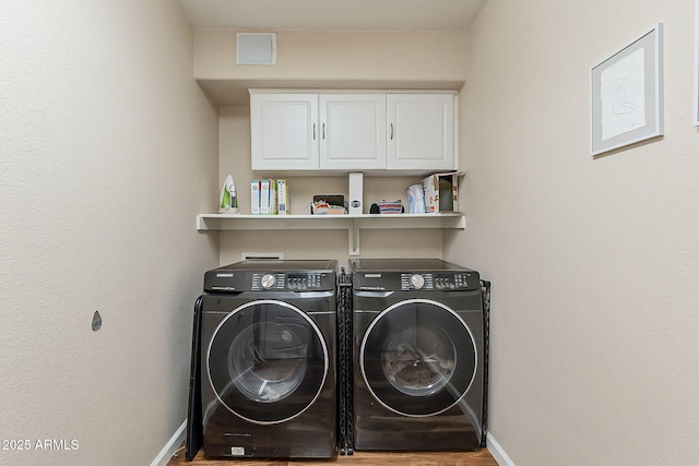 laundry room with cabinet space, independent washer and dryer, baseboards, and wood finished floors