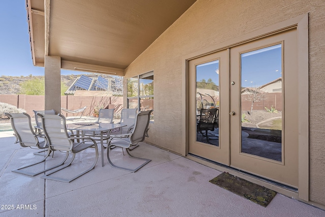 view of patio / terrace with french doors, outdoor dining area, and fence