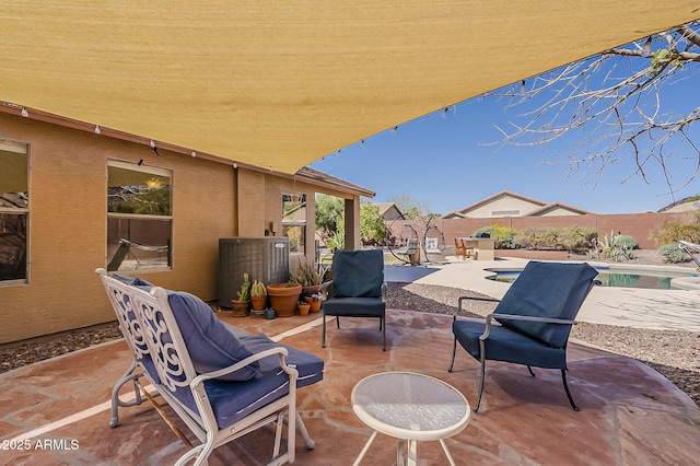 view of patio / terrace featuring a fenced in pool, central air condition unit, and a fenced backyard